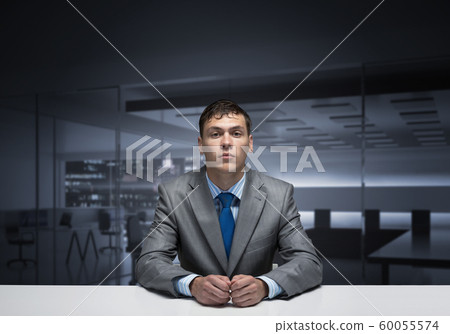 Young man folded hands and having serious face 60055574