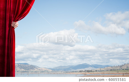 Summer natural bluesky view behind red velvet curtain Summer natural bluesky view behind red velvet curtain 60055581