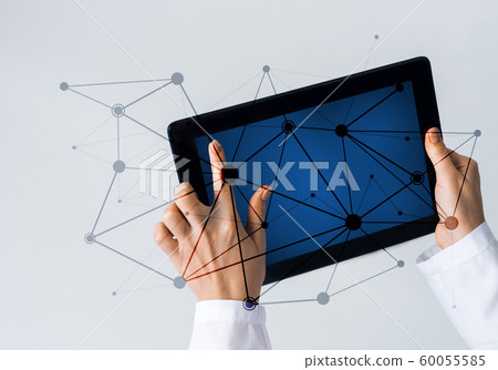 Close of female doctor hands working with tablet pc computer Close of female doctor hands working with tablet pc computer 60055585