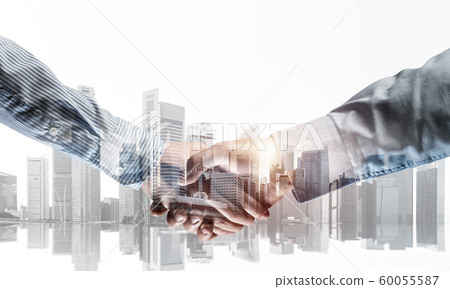 Business handshake as idea for unity and cooperation or greeting. Mixed media 60055587