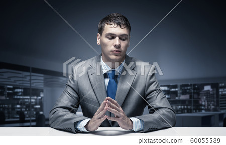 Young man folded hands and having serious face Young man folded hands and having serious face 60055589