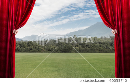 Asphalt road behind red curtain and hand holding it 60055740