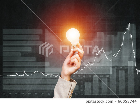 Woman hand with glowing incandescent lamp Woman hand with glowing incandescent lamp 60055744