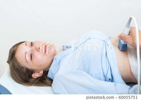 Doctor doing ultrasound screening checkup Doctor doing ultrasound screening checkup 60055751