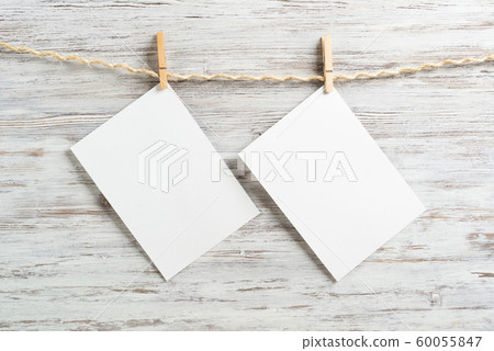 Blank sheets of paper hanging on rope Blank sheets of paper hanging on rope 60055847