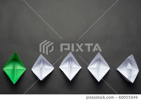 Row of paper ships on black background 60055849