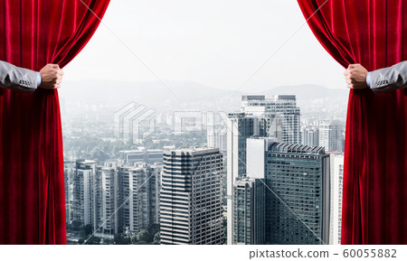 Modern business cityscape behind curtain opened by businessman hand Modern business cityscape behind curtain opened by businessman hand 60055882