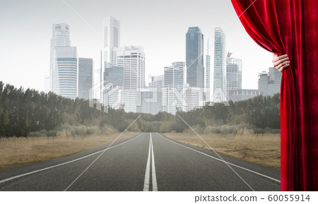 Asphalt road behind red curtain and hand holding it Asphalt road behind red curtain and hand holding it 60055914