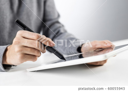 Businesswoman using tablet computer for news read Businesswoman using tablet computer for news read 60055943