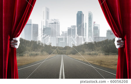 Asphalt road behind red curtain and hand holding it Asphalt road behind red curtain and hand holding it 60056208