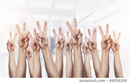 Row of man hands showing victory gesture Row of man hands showing victory gesture 60056209