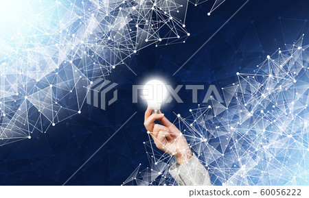 Human hand with glowing lamp and abstract network Human hand with glowing lamp and abstract network 60056222