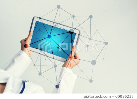 Close of female doctor hands working with tablet pc computer Close of female doctor hands working with tablet pc computer 60056235