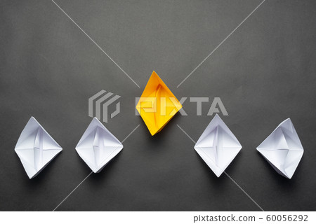 Row of paper ships on black background 60056292