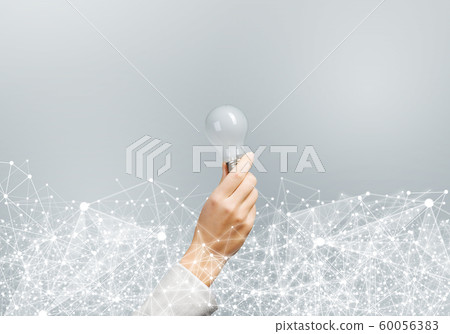 Woman hand holding light bulb and abstract network Woman hand holding light bulb and abstract network 60056383