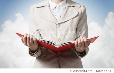 Business woman holding open notebook 60056384