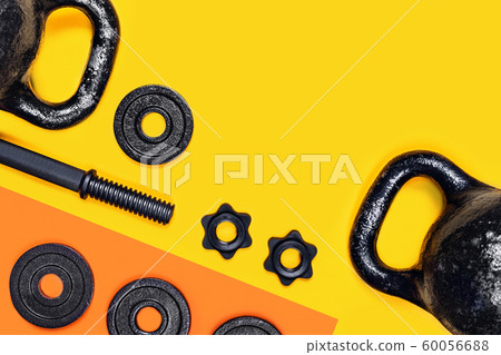 Kettlebell and dumbbell on color background. 60056688