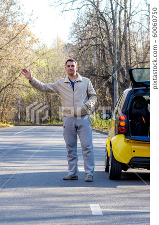 Man by his car waits for help 60060750