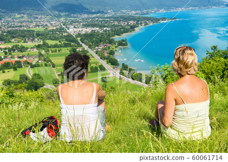 Two women watching  view of Lake Annecy 60061714