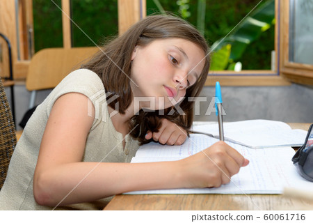 teenager doing her homework 60061716