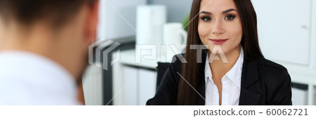 Beautiful smiling brunette clerk girl at workplace 60062721