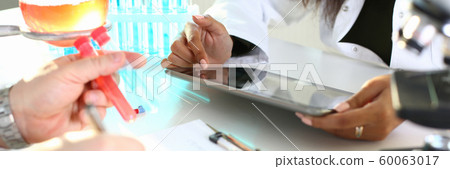 A male chemist holds test tube of glass A male chemist holds test tube of glass 60063017