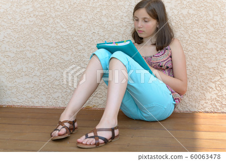 girl with straight long hair sitting on the floor. girl with straight long hair sitting on the floor. 60063478