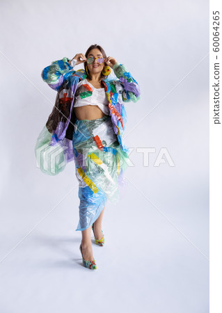 Woman addicted of sales and clothes, wearing plastic, recycling concept 60064265