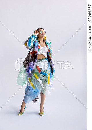 Woman addicted of sales and clothes, wearing plastic, recycling concept Woman addicted of sales and clothes, wearing plastic, recycling concept 60064277