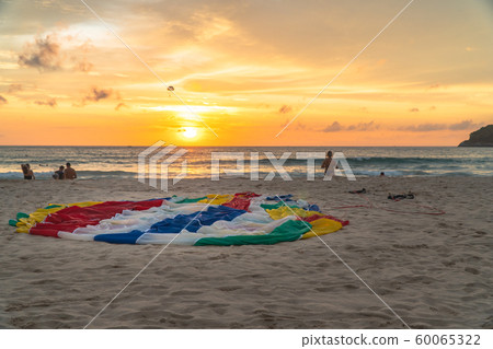 parasail on the beach in sunset 60065322