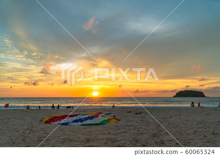 parasail on the beach in sunset 60065324