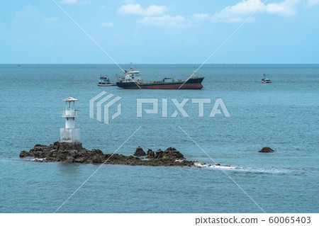 cargo boats moored near the lighthouse 60065403