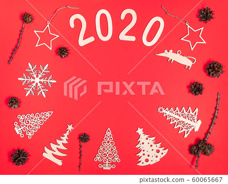 Creative Christmas composition. Xmas handmade wooden decorations: Christmas trees, stars, snowflake, rat, numbers 2020, pine cones on red background. Festive mockup. Flat lay, top view, copy space. Creative Christmas composition. Xmas handmade wooden decorations: Christmas trees, stars, snowflake, rat, numbers 2020, pine cones on red background. Festive mockup. Flat lay, top view, copy space. 60065667