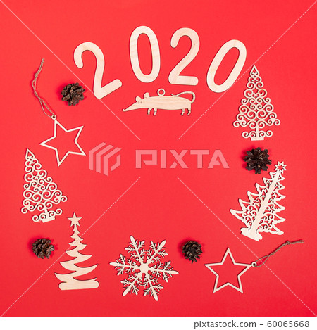 Creative christmas mockup on red background with handmade wooden xmas decorations: Christmas trees, stars, snowflake, rat, numbers 2020, pine cones. Flat lay, top view, copy space, square photo. Creative christmas mockup on red background with handmade wooden xmas decorations: Christmas trees, stars, snowflake, rat, numbers 2020, pine cones. Flat lay, top view, copy space, square photo. 60065668