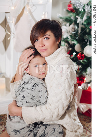 Boy with beautiful mom embracing in decorated 60065842