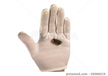 Hand in white glove holds one bullet on an open 60066019