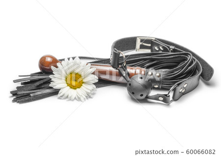 bdsm black leather lash with gag and yellow daisy flower on a white background bdsm black leather lash with gag and yellow daisy flower on a white background 60066082