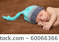 Baby boy sleeping on a carpet at home 60066366