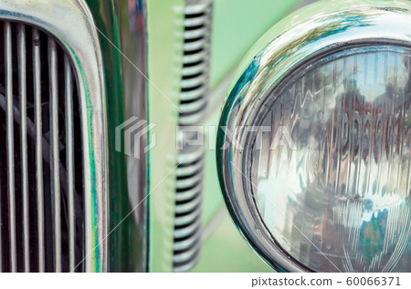 headlight and radiator of an old retro car close up headlight and radiator of an old retro car close up 60066371