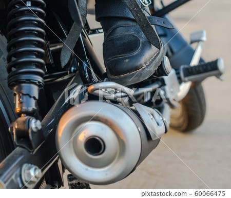 moto biker boots on motorcycle background close up moto biker boots on motorcycle background close up 60066475