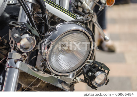 chrome shiny chopper motorcycle headlight close up 60066494