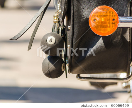 talisman balls on a motorcyclist leather bag close up 60066499