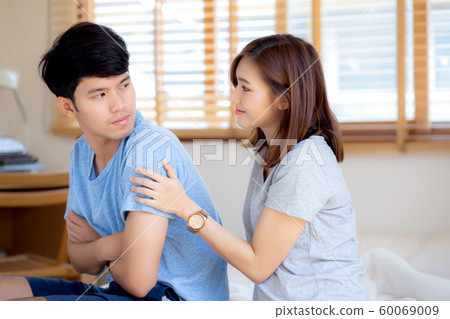 Young asian couple a problem and woman ask forgive and sorry with man feeling angry at bedroom 60069009