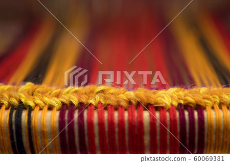 Detail of traditional vintage weaving hand loom with wool close up. Weaving background Detail of traditional vintage weaving hand loom with wool close up. Weaving background 60069381