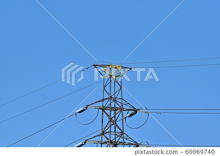 Transmission line tower towering against the blue sky Transmission line tower towering against the blue sky 60069740