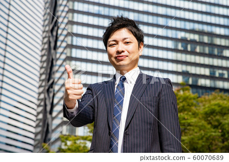 Businessman posing for "thumb up" Businessman posing for "thumb up" 60070689