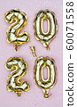 Happy New year 2020 celebration. Gold foil balloons numeral 2020 and golden stars on pastel pink 60071558