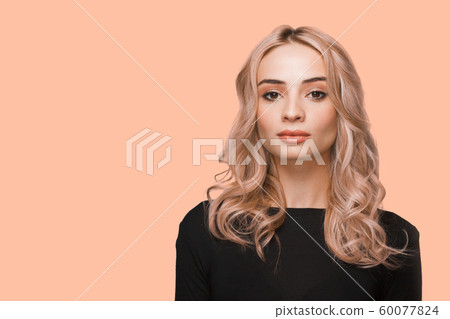 Fashion portrait of young beautiful woman with no jewelry. Blonde girl with elegant hairstyle on long wavy hair. Natural make-up. Fashion portrait of young beautiful woman with no jewelry. Blonde girl with elegant hairstyle on long wavy hair. Natural make-up. 60077824