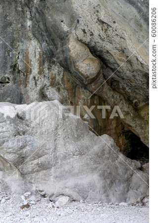 Large natural textured brown-grey-white stone blocks with uneven surface. 60086206