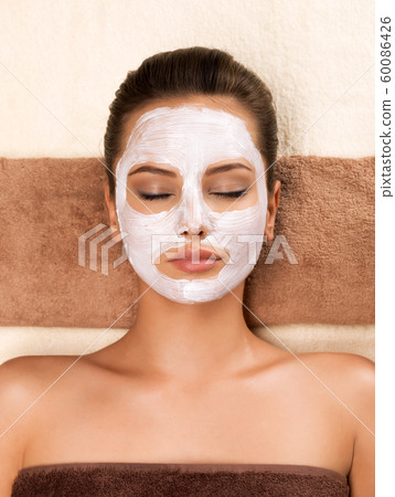 Young woman with mask on her face relaxing in the Young woman with mask on her face relaxing in the 60086426